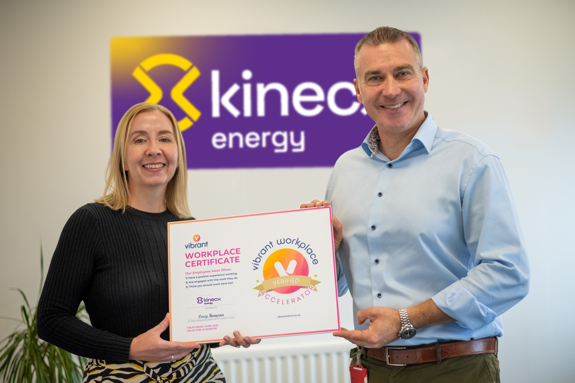 Picture of Niall Martindale (CEO) and Olga Pollock (HR Manager) holding their Vibrant Workplace certificate